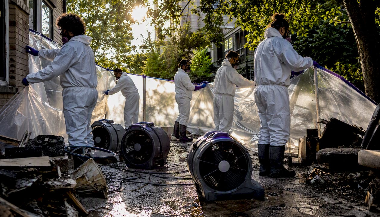 Flood cleanup crew in PPE preparing equipment