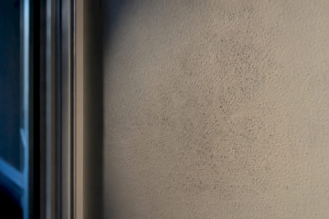 Soot particles trapped in drywall texture