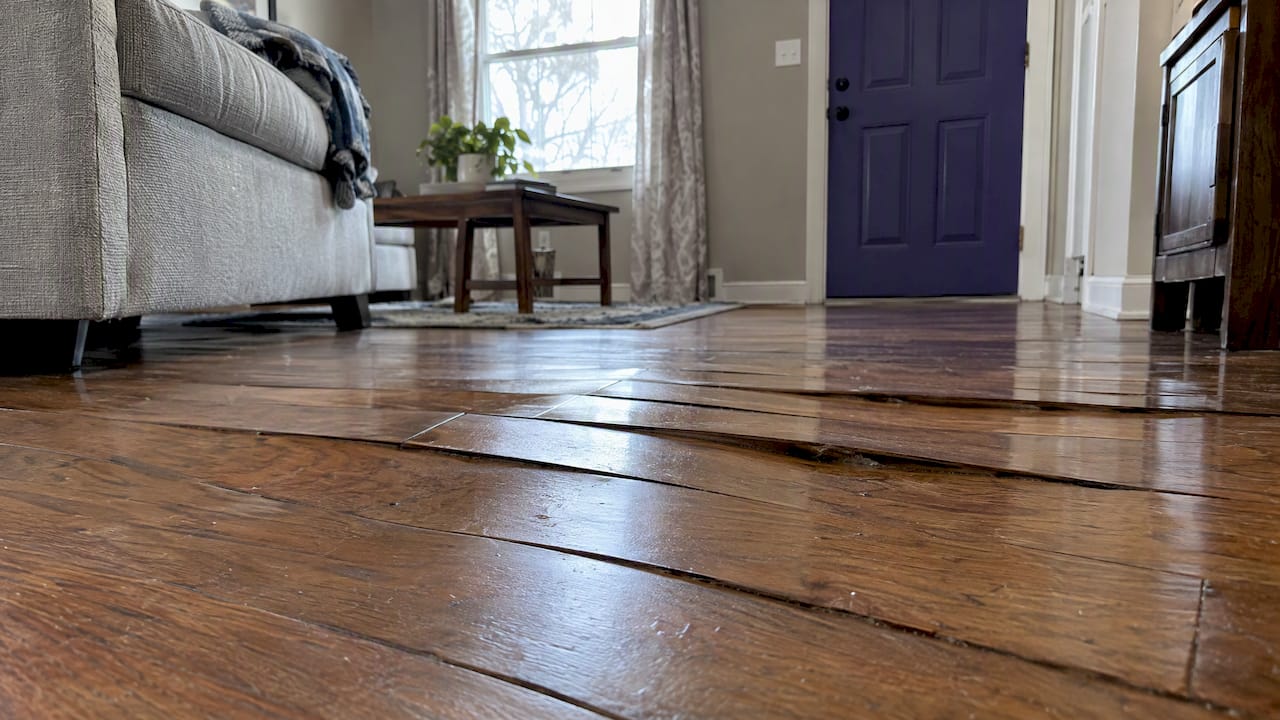 Hardwood boards buckled upward after water damage